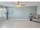 Bright living room featuring tile floors, ceiling fan and natural light at 1001 77Th N Ave # 206, St Petersburg, FL 33702