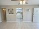Living room with tile floors and glimpse into kitchen with white cabinets and appliances at 1001 77Th N Ave # 206, St Petersburg, FL 33702