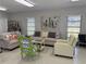 A welcoming living area features comfortable couches, stylish decor, and a bright atmosphere from outside at 1001 77Th N Ave # 206, St Petersburg, FL 33702