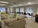 A large living room features multiple seating areas, tables, and ample space for gatherings at 1001 77Th N Ave # 206, St Petersburg, FL 33702