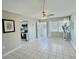 Living room with tiled floors and ceiling fan leading out to enclosed porch with large door at 1001 77Th N Ave # 206, St Petersburg, FL 33702