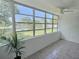 Enclosed patio with tile floors and view of pool area at 1001 77Th N Ave # 206, St Petersburg, FL 33702