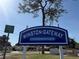 Winston-Gateway Condominiums signage offers a glimpse of the neighborhood homes and a lush tree at 1001 77Th N Ave # 206, St Petersburg, FL 33702