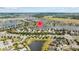 Wide aerial shot of a residential area with lakes and green spaces, marked with a house icon at 10017 Smarty Jones Dr, Ruskin, FL 33573