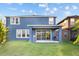 Backyard features a covered patio, grill, lawn, and two story home at 10017 Smarty Jones Dr, Ruskin, FL 33573
