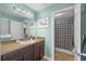 Bathroom with double sink vanity and framed mirror with modern lighting at 10017 Smarty Jones Dr, Ruskin, FL 33573