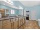 Bright bathroom with double vanity, granite counters, and walk-in shower at 10017 Smarty Jones Dr, Ruskin, FL 33573