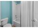 Cozy bathroom features a bathtub and shower combination against a backdrop of blue and white tiling at 10017 Smarty Jones Dr, Ruskin, FL 33573