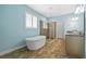 Bright bathroom with standalone tub, shower, blue walls, and tile flooring at 10017 Smarty Jones Dr, Ruskin, FL 33573