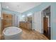 This spacious bathroom features a shower, soaking tub, and a dual vanity at 10017 Smarty Jones Dr, Ruskin, FL 33573