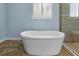 This bathroom features a soaking tub situated between a shower and window at 10017 Smarty Jones Dr, Ruskin, FL 33573