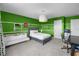 Comfortable bedroom featuring colorful green walls, white futon, desk, and decor at 10017 Smarty Jones Dr, Ruskin, FL 33573