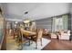 Sophisticated dining area with a large table, chairs, chandelier and hardwood flooring at 10017 Smarty Jones Dr, Ruskin, FL 33573