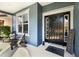 Inviting front door with sidelights, a welcome mat, and decorative rocking chairs on a porch at 10017 Smarty Jones Dr, Ruskin, FL 33573