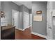 Hallway featuring wood floors, neutral walls, and white doors, leading to various rooms at 10017 Smarty Jones Dr, Ruskin, FL 33573