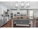 Kitchen featuring stainless steel refrigerator, center island, modern lighting, and white cabinetry at 10017 Smarty Jones Dr, Ruskin, FL 33573