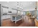 Open kitchen with stainless steel appliances, central island, and adjacent dining area at 10017 Smarty Jones Dr, Ruskin, FL 33573