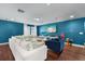 Bright living room features colorful walls and a large white sectional couch at 10017 Smarty Jones Dr, Ruskin, FL 33573