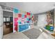 Bright playroom with colorful accent wall, storage, and a carpet at 10017 Smarty Jones Dr, Ruskin, FL 33573