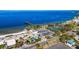 Aerial image showcasing amenities, a beach, a pier, and a tiki bar at 1025 Seagrape Dr, Ruskin, FL 33570