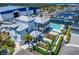 Aerial view of a modern complex showcasing a beautiful pool, lush landscaping, and a marina nearby at 1025 Seagrape Dr, Ruskin, FL 33570