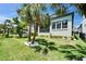 Backyard featuring green grass, mature trees, and house exterior at 1025 Seagrape Dr, Ruskin, FL 33570