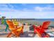 Beachside setting with colorful Adirondack chairs arranged around a fire pit, offering a cozy relaxation spot at 1025 Seagrape Dr, Ruskin, FL 33570