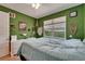 Stylish green bedroom with nice natural light, decor, and dresser at 1025 Seagrape Dr, Ruskin, FL 33570