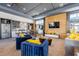 Spacious common room includes a modern kitchen area, stylish seating, and a TV at 1025 Seagrape Dr, Ruskin, FL 33570