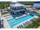 Community pool area showcases deck chairs, umbrellas, and a covered recreation center at 1025 Seagrape Dr, Ruskin, FL 33570