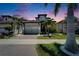 Beautiful home featuring a two-car garage and lush tropical landscaping in front at 1025 Seagrape Dr, Ruskin, FL 33570