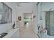 Hallway with white tile floors, staircase, and access to the main living area at 1025 Seagrape Dr, Ruskin, FL 33570