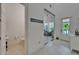Bright foyer with white tiled floors, a glass enclosed office, and an exterior door at 1025 Seagrape Dr, Ruskin, FL 33570