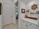 Nautical themed hallway featuring decor, white cabinets and countertops, and tile floors at 1025 Seagrape Dr, Ruskin, FL 33570