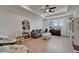 Bright living room with hardwood floors, a ceiling fan, comfortable seating, and natural light at 1025 Seagrape Dr, Ruskin, FL 33570