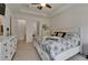 Comfortable main bedroom showcasing a tray ceiling, tiled floor, and neutral colors, offering a relaxing retreat at 1025 Seagrape Dr, Ruskin, FL 33570