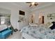 Well-lit main bedroom with tray ceilings, tiled flooring, and a closet, offering a restful escape at 1025 Seagrape Dr, Ruskin, FL 33570