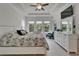 Spacious main bedroom with tray ceilings, plenty of natural light from multiple windows, and contemporary decor at 1025 Seagrape Dr, Ruskin, FL 33570