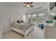 Bright main bedroom featuring tray ceilings, multiple windows, and stylish furnishings, creating a serene and inviting space at 1025 Seagrape Dr, Ruskin, FL 33570