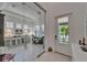 Well-lit office with a glass door entry for privacy and a view of the lush outdoors at 1025 Seagrape Dr, Ruskin, FL 33570