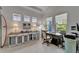 Bright home office boasts natural light, a custom built-in desk and three windows at 1025 Seagrape Dr, Ruskin, FL 33570