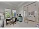 Home office with a sleek glass door, modern furniture, and bright natural lighting at 1025 Seagrape Dr, Ruskin, FL 33570