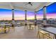 Outdoor covered patio with tables and chairs offers beautiful views of the marina and picturesque sunset at 1025 Seagrape Dr, Ruskin, FL 33570
