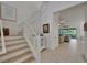 Bright staircase featuring white wooden banisters, wood treads, and access to the living room at 1025 Seagrape Dr, Ruskin, FL 33570