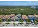 Attractive street with modern homes, palm trees, and a glimpse of natural green space at 1025 Seagrape Dr, Ruskin, FL 33570