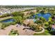 Aerial view featuring apartments, a pool, and a lake at 10265 Gandy N Blvd # 1406, St Petersburg, FL 33702