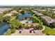Aerial view showcases apartments, a pool, and a lake at 10265 Gandy N Blvd # 1406, St Petersburg, FL 33702
