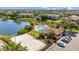 Aerial view of the community amenities, including a pool, clubhouse, volleyball court, and beautiful lake at 10265 Gandy N Blvd # 1406, St Petersburg, FL 33702