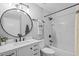 Updated bathroom featuring a shower over tub with white marble, matte black hardware, and a round mirror at 10265 Gandy N Blvd # 1406, St Petersburg, FL 33702