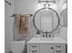 Contemporary bathroom with round mirror, modern lighting, and upgraded fixtures at 10265 Gandy N Blvd # 1406, St Petersburg, FL 33702